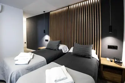 two beds sitting next to each other in a room at La Orza de Angel in Chiva