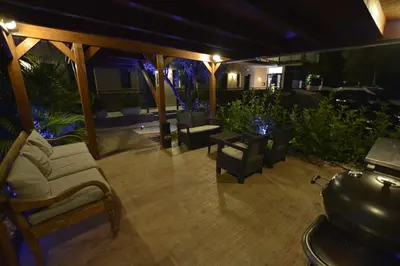 a patio at night with chairs and lights at Hotel Vista al Sol in Paterna