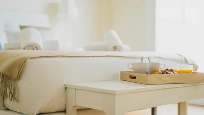 a white bed with a table with a box on it at HQ Rooms Apartments San Vicente in Valencia