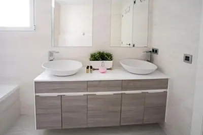 two sinks in a bathroom with two mirrors at HQ Rooms Apartments San Vicente in Valencia