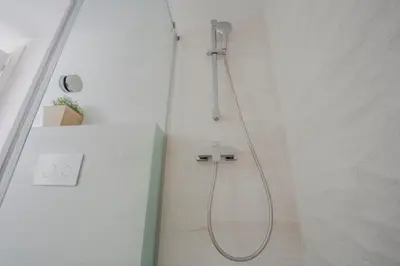 a shower with a shower head in a bathroom at HQ Rooms Apartments San Vicente in Valencia