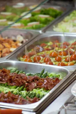 a buffet of different types of food in trays at Olympia Ronda Hostel in El Puig