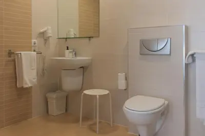 a small bathroom with a toilet and a sink at Dormavalencia Hostel Regne in Valencia