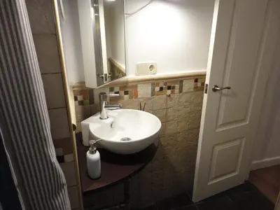 a bathroom with a white sink and a mirror at Center Valencia in Valencia