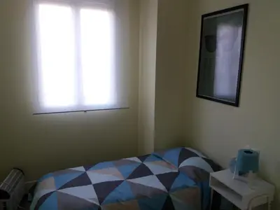 a bedroom with a bed and two windows at El Católico 56 in Valencia