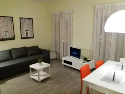 a living room with a couch and a tv at El Católico 56 in Valencia