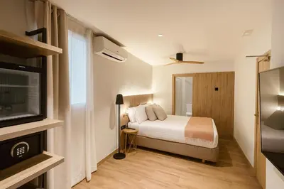 a bedroom with a bed and a flat screen tv at Nommadas Jero - Only Adults in Valencia