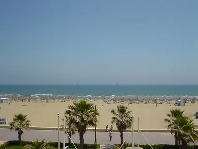 a beach with a lot of people and the ocean at Apartamento playa Las Arenas in Valencia