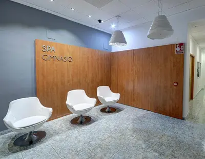 two white chairs sitting in a room with a wall at Hotel Vila-real Azul in Villareal