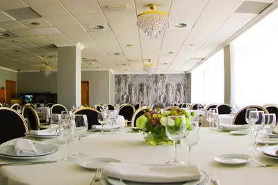a conference room with a long table with glasses and chairs at Hotel Vila-real Palace in Villareal