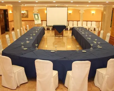 a meeting room with a blue table and chairs at Casa Quiquet in Beniparrell