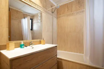 a bathroom with a sink and a mirror and a tub at Exclusive Museum in Valencia