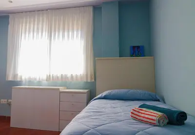 a bedroom with a bed with a dresser and a window at Casa Torre del Virrey in La Eliana
