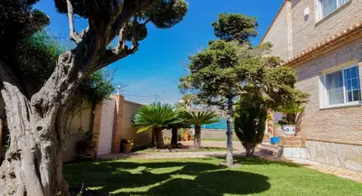 a house with a yard with trees and a building at Casa Torre del Virrey in La Eliana