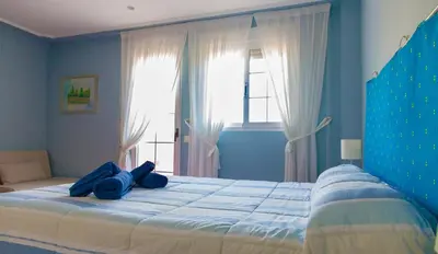 a blue bedroom with a bed with blue towels on it at Casa Torre del Virrey in La Eliana