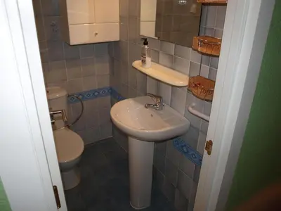 a bathroom with a sink and a toilet at Apt. New Holiday Valencia Beach in El Puig
