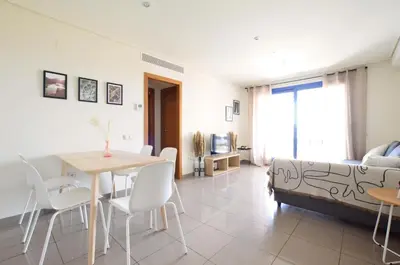 a living room with a table and a couch at Apartamento frente al mar in Valencia