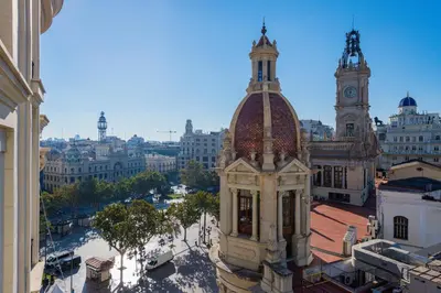 a building with a clock tower in a city at Ayuntamiento Panoramic in Valencia