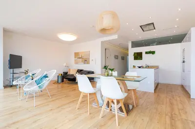 a kitchen and living room with a table and chairs at Ayuntamiento Panoramic in Valencia