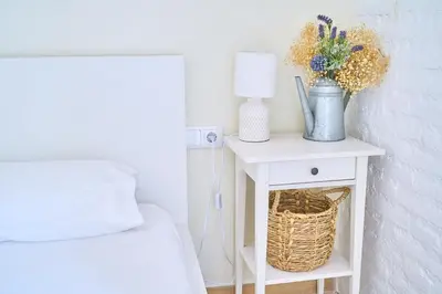 a bedroom with a bed and a table with a lamp at Splendid houses in Valencia in Valencia