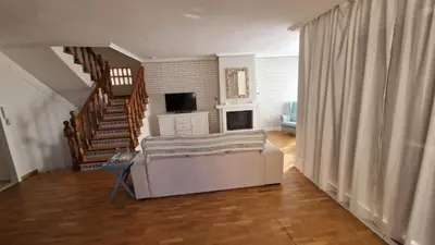 a living room with a couch and a staircase at Beachfront vila in Valencia