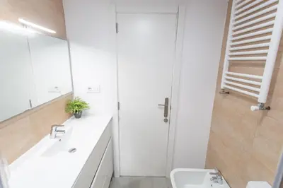 a white bathroom with a sink and a shower at VLC - Cisneros in Valencia