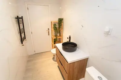 a bathroom with a sink and a toilet and a tub at VLC - Cisneros in Valencia