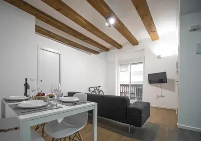 a living room with a table and a couch at Ambrosio Flats Valencia - El Mercat in Valencia