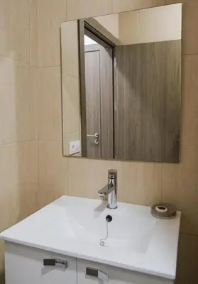 a bathroom with a white sink and a mirror at Hostal Tartessos in Valencia