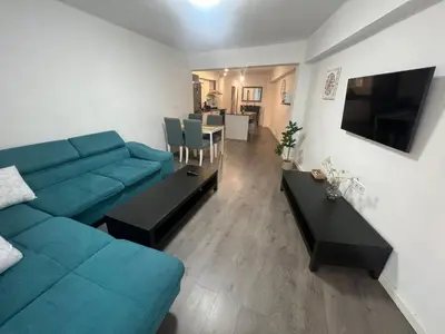 a living room with a blue couch and a table at Sweet Home in Valencia
