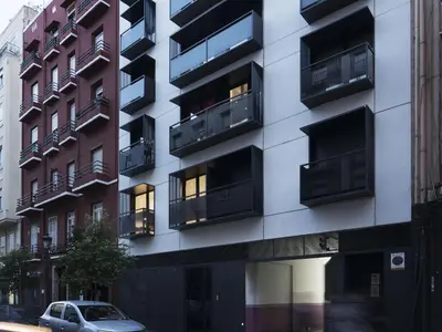 an apartment building with balconies on a city street at Flat El Porto - Valencia in Valencia