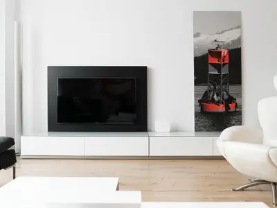 a living room with a tv on a white cabinet at Flat El Porto - Valencia in Valencia