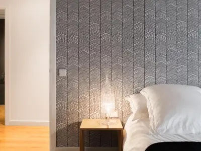 a bedroom with a bed and a table with a lamp at Flat El Porto - Valencia in Valencia
