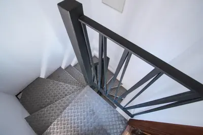 a stairwell with a metal railing and a glass ceiling at Apartamentos La Xerea in Valencia