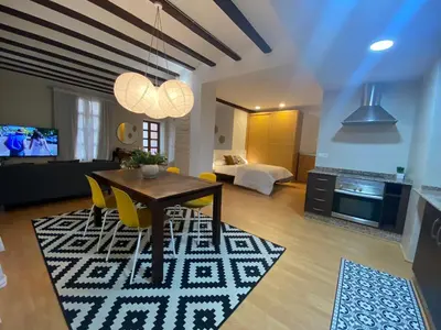 a living room with a dining table and a living room at Apartamentos La Xerea in Valencia