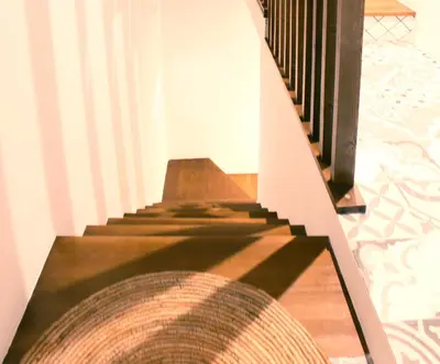 a staircase in a house with a shadow on the floor at Casa Los gorgos in Anna