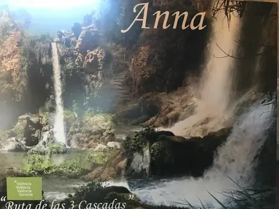 a book with a picture of a waterfall at Casa Los gorgos in Anna