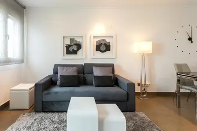 a living room with a blue couch and a table at ApartUP Patacona Terrace Duplex II in Valencia