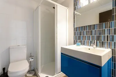 a bathroom with a toilet and a sink and a shower at ApartUP Patacona Terrace Duplex II in Valencia