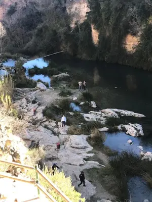 a group of people standing on rocks near a river at Casa del Agua in Anna