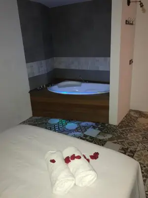 a bathroom with a tub and two towels on a bed at Casa del Agua in Anna