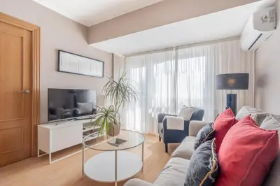 a living room with a couch and a table at 1ªLinea de playa Puerto de Sagunto in Puerto de Sagunto