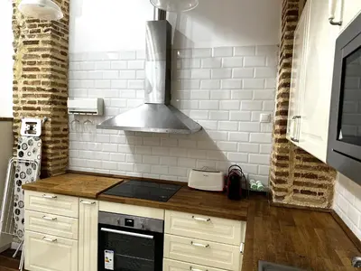 a kitchen with a stove and a stove top oven at Botanico Silence in Valencia