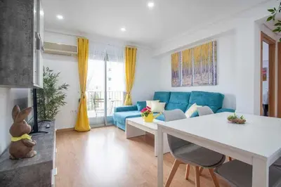 a living room with a blue couch and a table at Reus, Lovely Flat Close to Center in Valencia