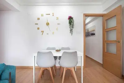 a white table with two chairs and a clock on the wall at Reus, Lovely Flat Close to Center in Valencia