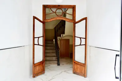 a hallway with a mirror and a stairway at Hola Valencia - Holiday Apartments in Valencia