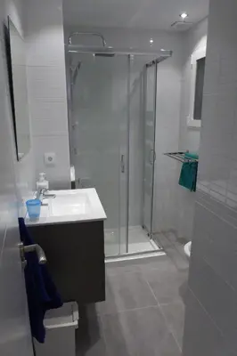 a bathroom with a shower and a sink and a glass shower door at Malvarossa apartment near beach in Valencia