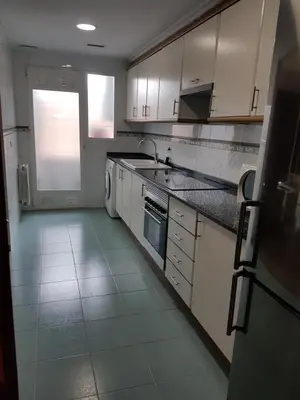 a kitchen with white cabinets and a sink and a dishwasher at Apartamento Ciencias y Playa in Valencia