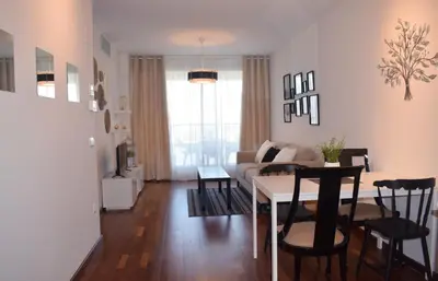 a living room with a table and a couch at River Park Valencia in Valencia
