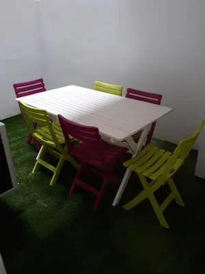 a white table with four colorful chairs around it at Belchite in Valencia